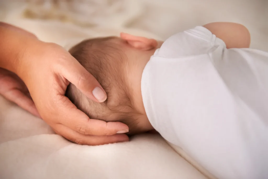 infant resting head with gentle hand 2026 03 25 02 43 41 utc 1